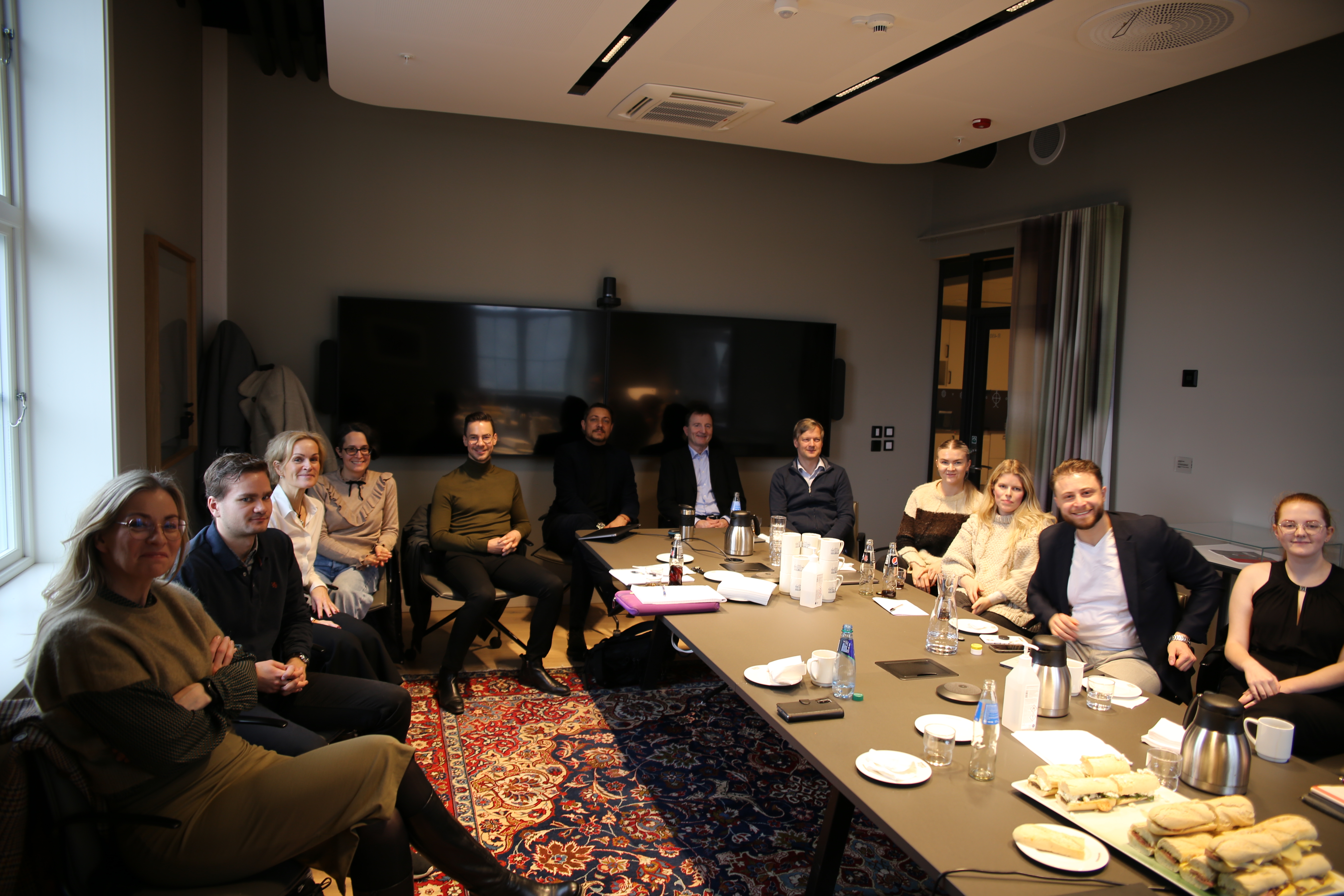 Some of the researchers posing for a picture in a meeting room. 
