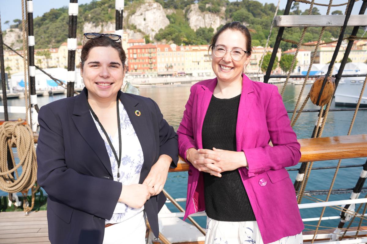 Two persons standing together on a ship. 