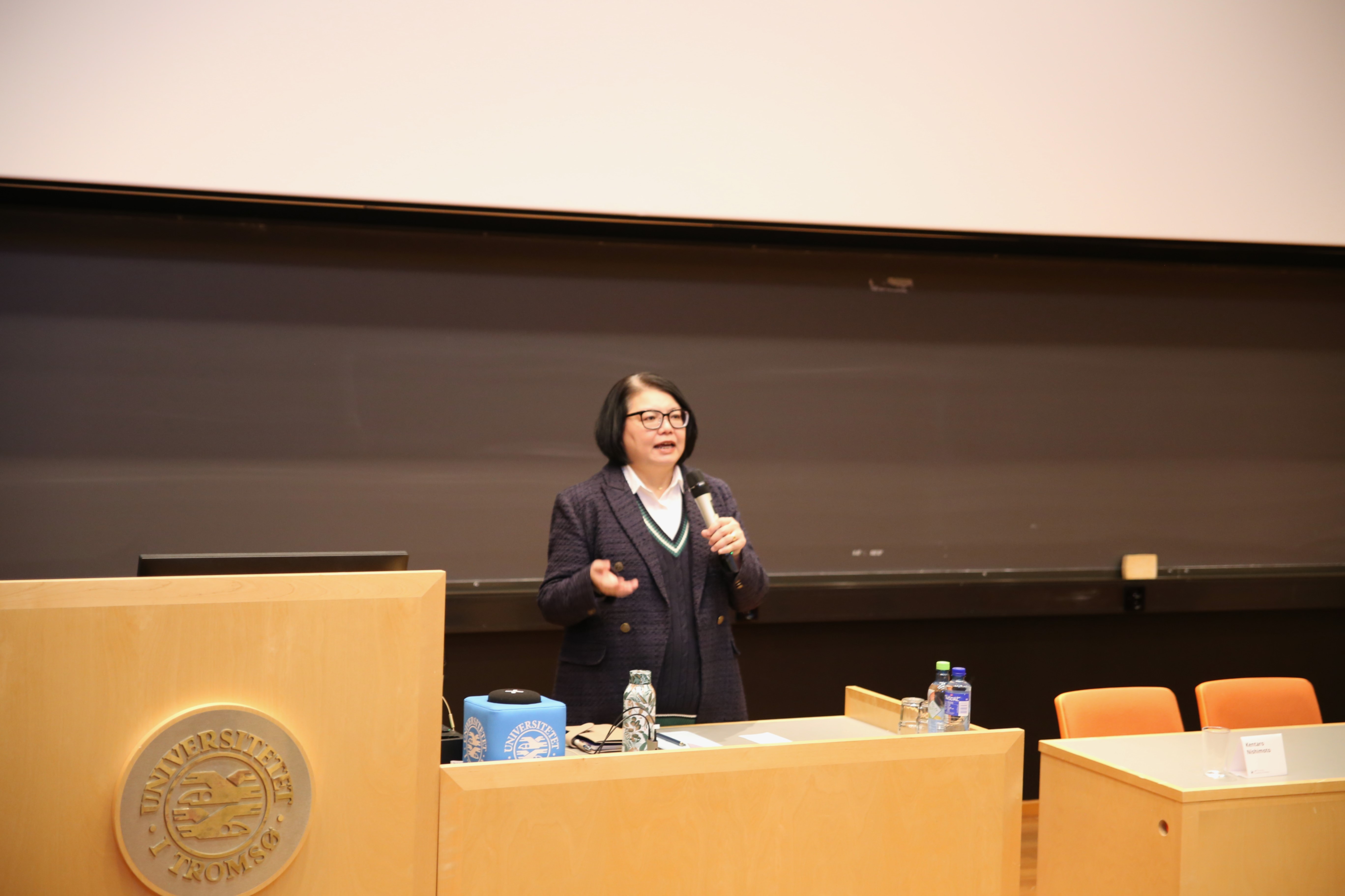 Woman speaking to an audience. 