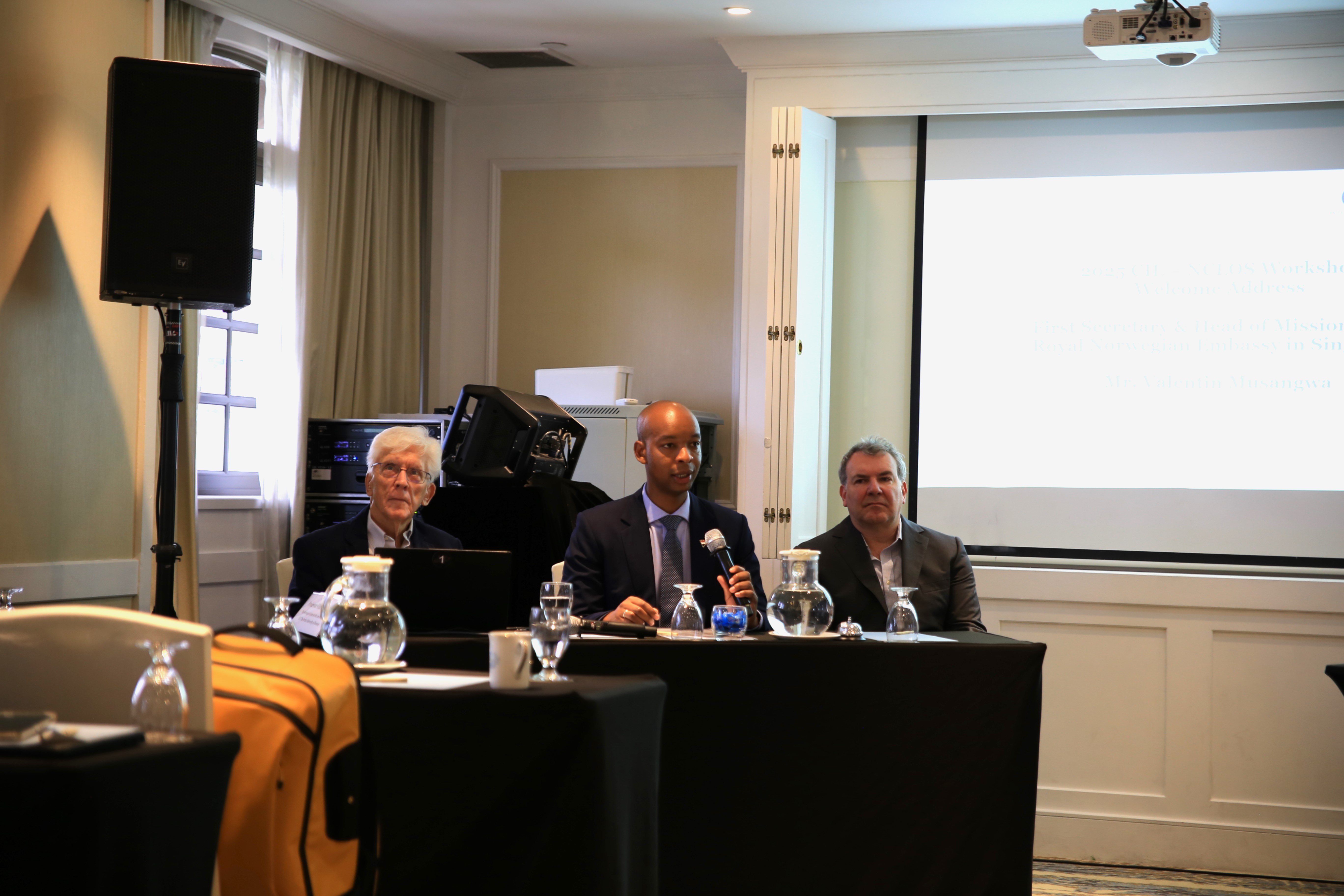 three men discussing in a panel disucssion