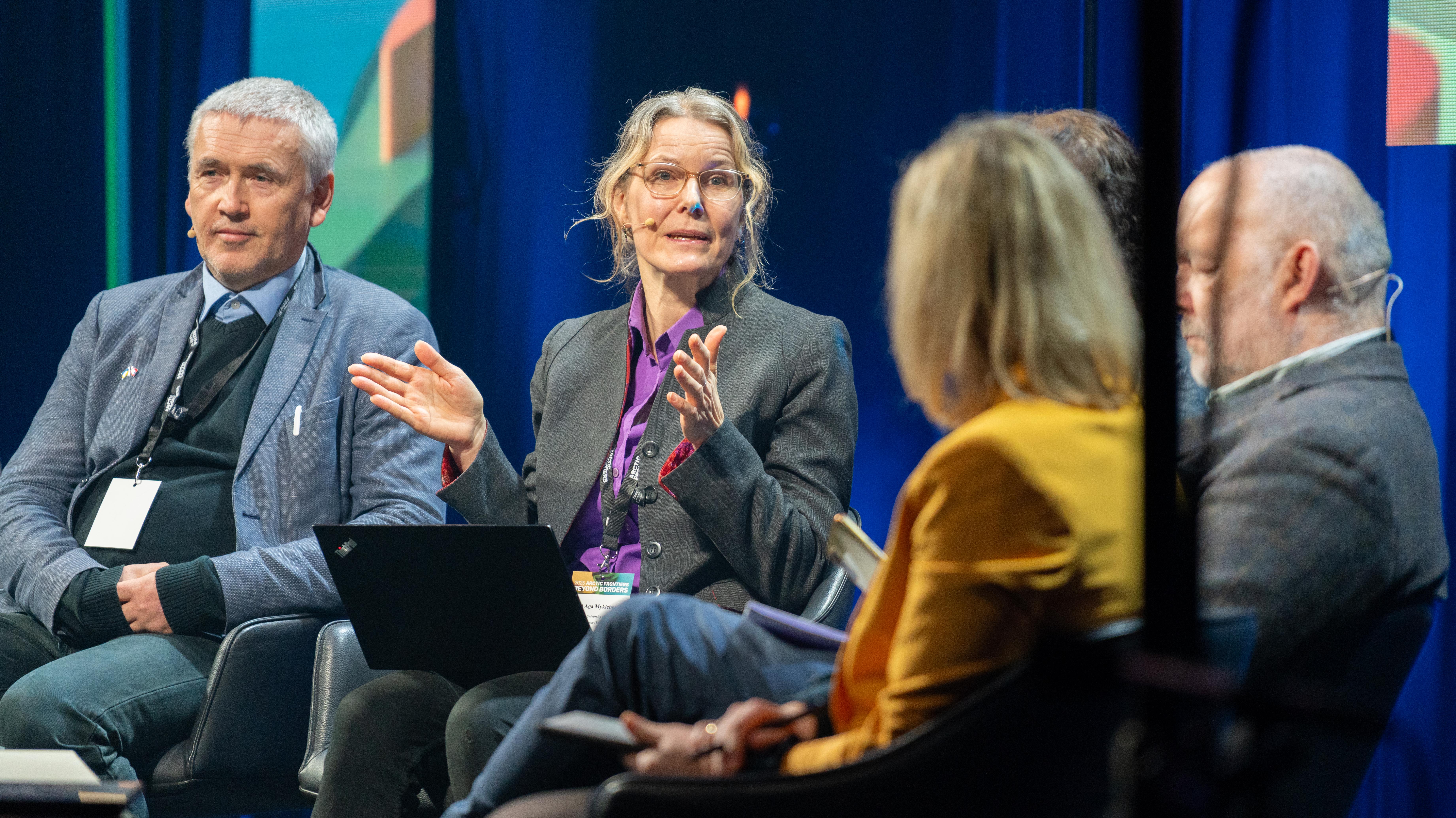 Four people sitting on chairs.