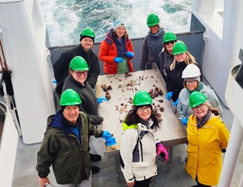Picture1.jpg People gathered on the deck of a boat.